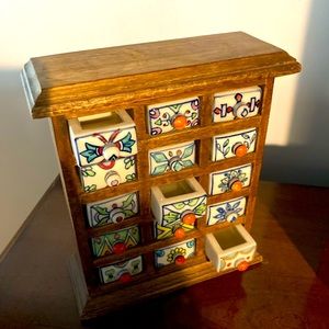 Small wooden curio with glass drawers